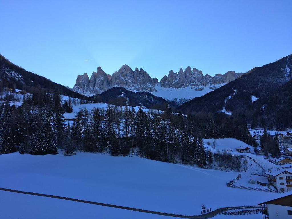a view of a snow covered valley with mountains at Fallerhof in Villnoss