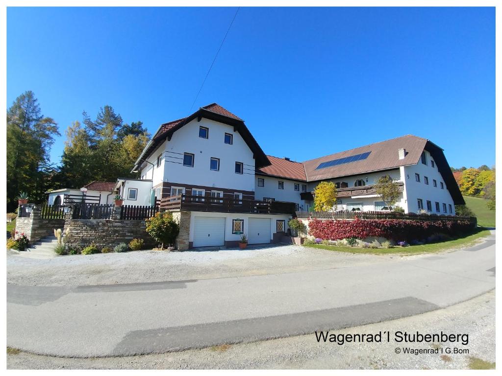 a large white house on the side of a road at Ferienwohnungen Wagenradl Stubenberg in Stubenberg