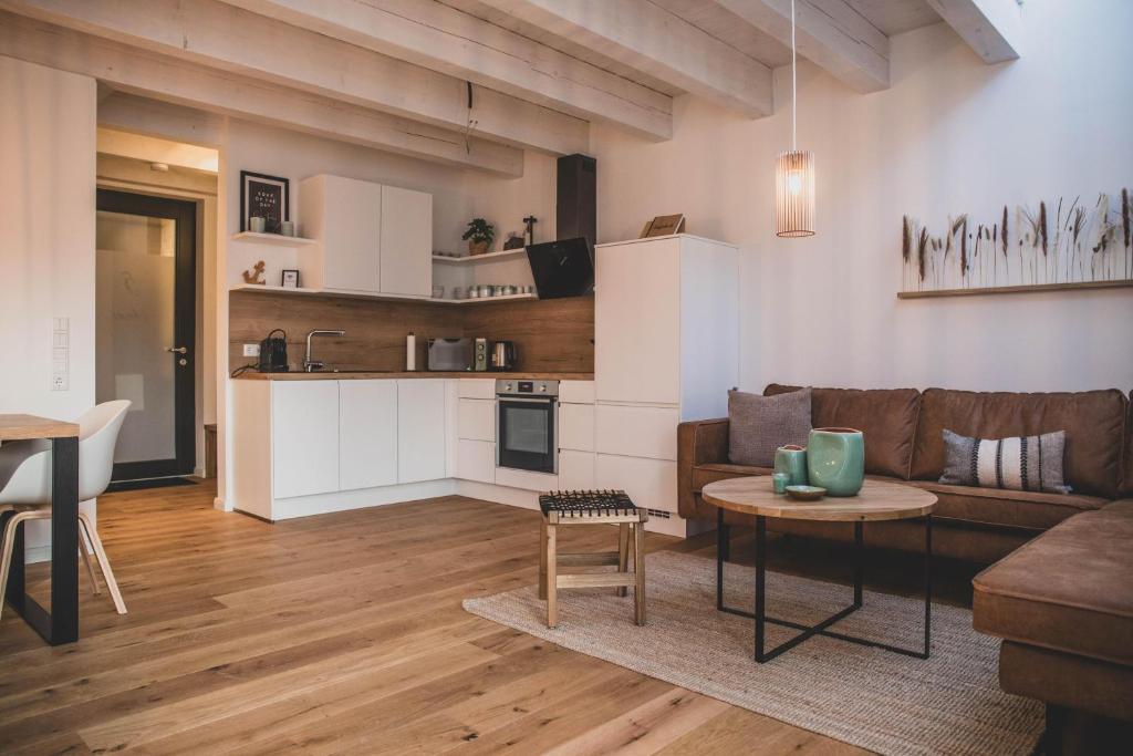 a living room with a couch and a table at Van Senden 5 Anni in Krummhörn
