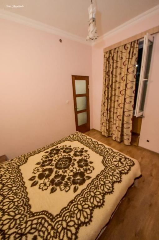 Postel nebo postele na pokoji v ubytování Apartment Soho Tabidze