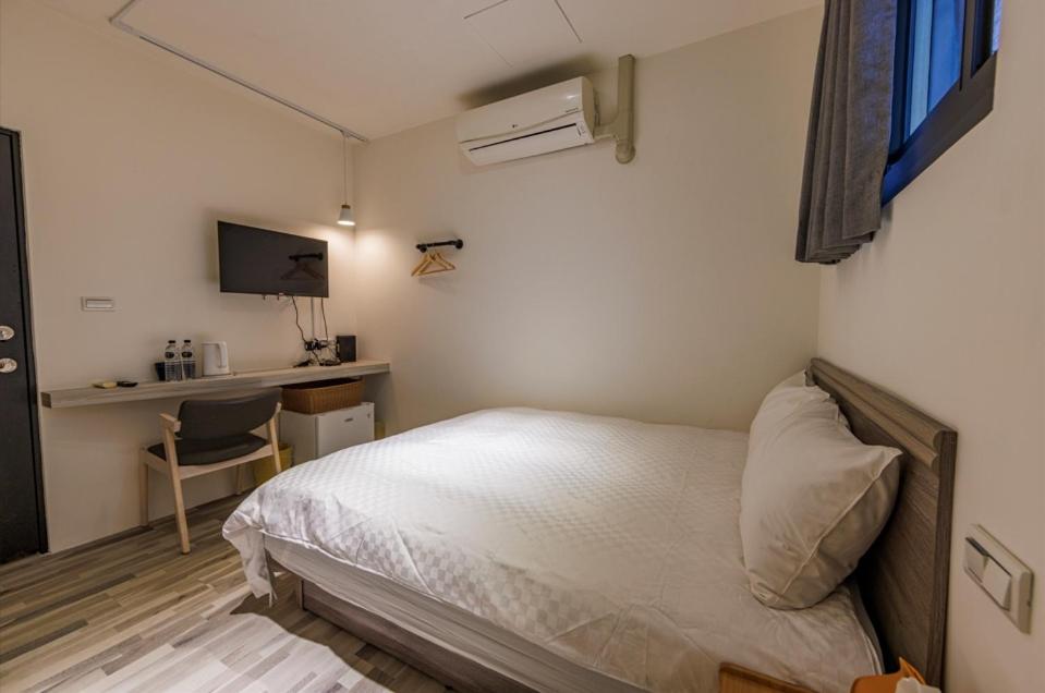 Postel nebo postele na pokoji v ubytování 鄉都文旅