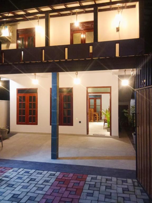 a view of the front of a house at night at Tranquil Cottage in Ahangama