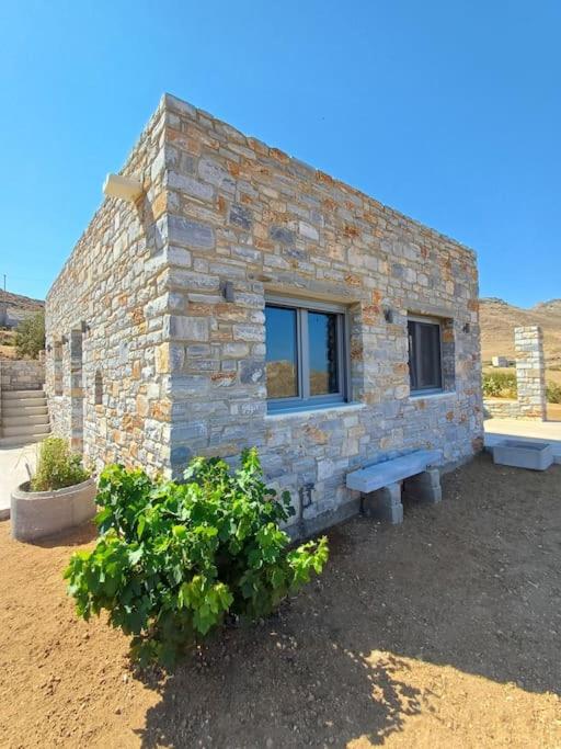 a stone building with a bench in front of it at Akallis Villa in Galini