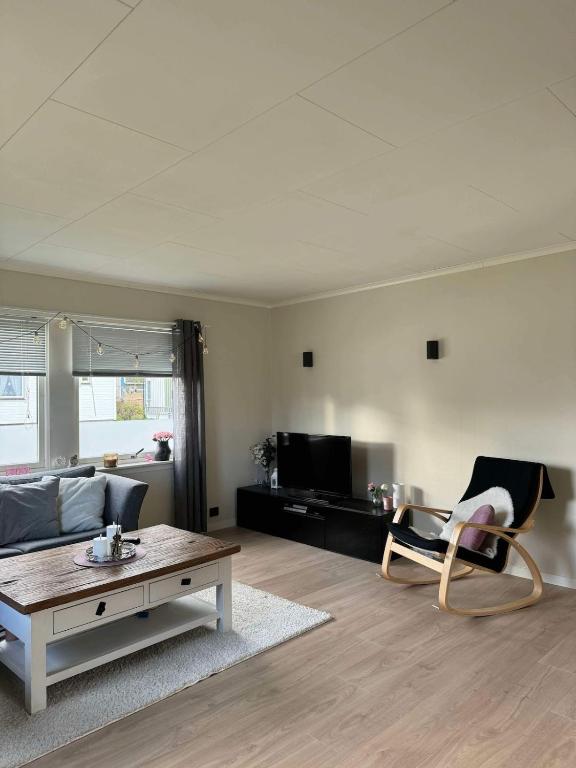 a living room with a couch and a coffee table at Arctic Haven Apartment in Berlevåg