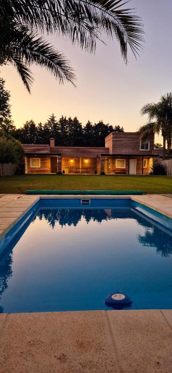 a swimming pool in front of a house at La Gualeyita in Gualeguay
