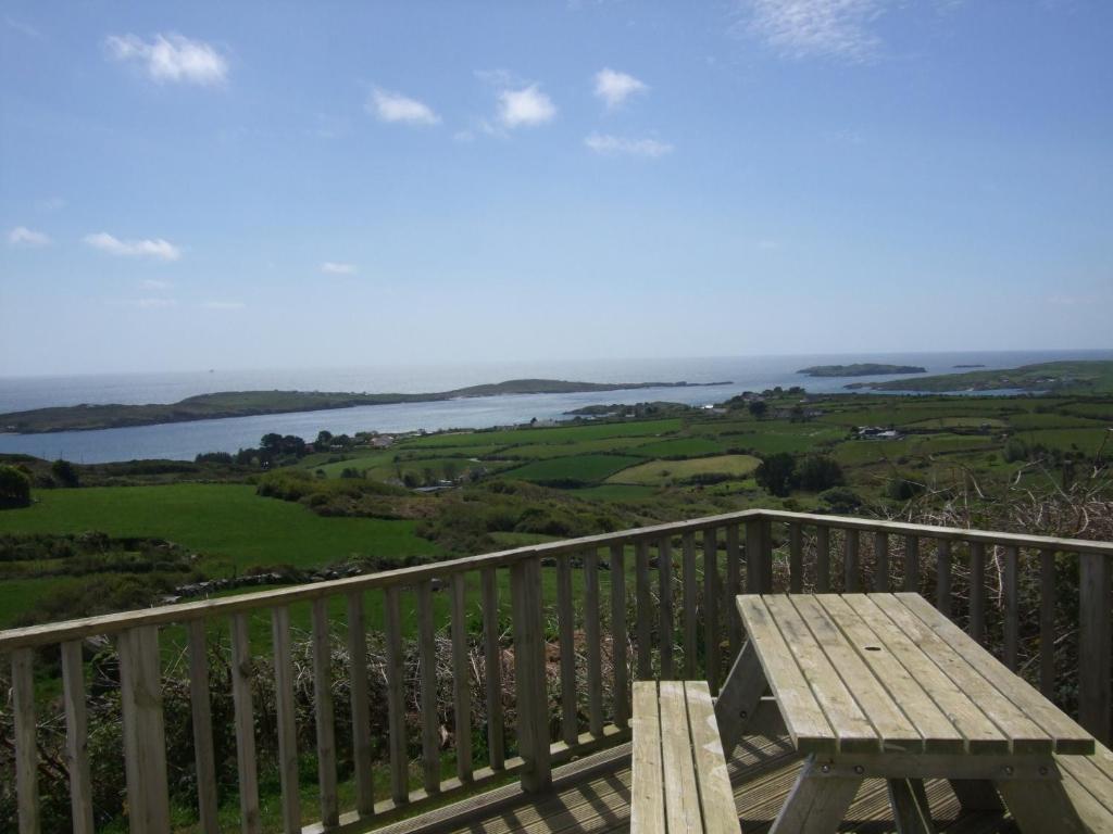 a wooden bench sitting on top of a balcony at Ardeevan Schull in Schull