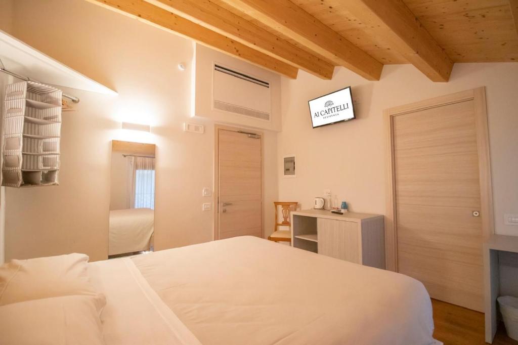 Postel nebo postele na pokoji v ubytování Residenza Ai Capitelli