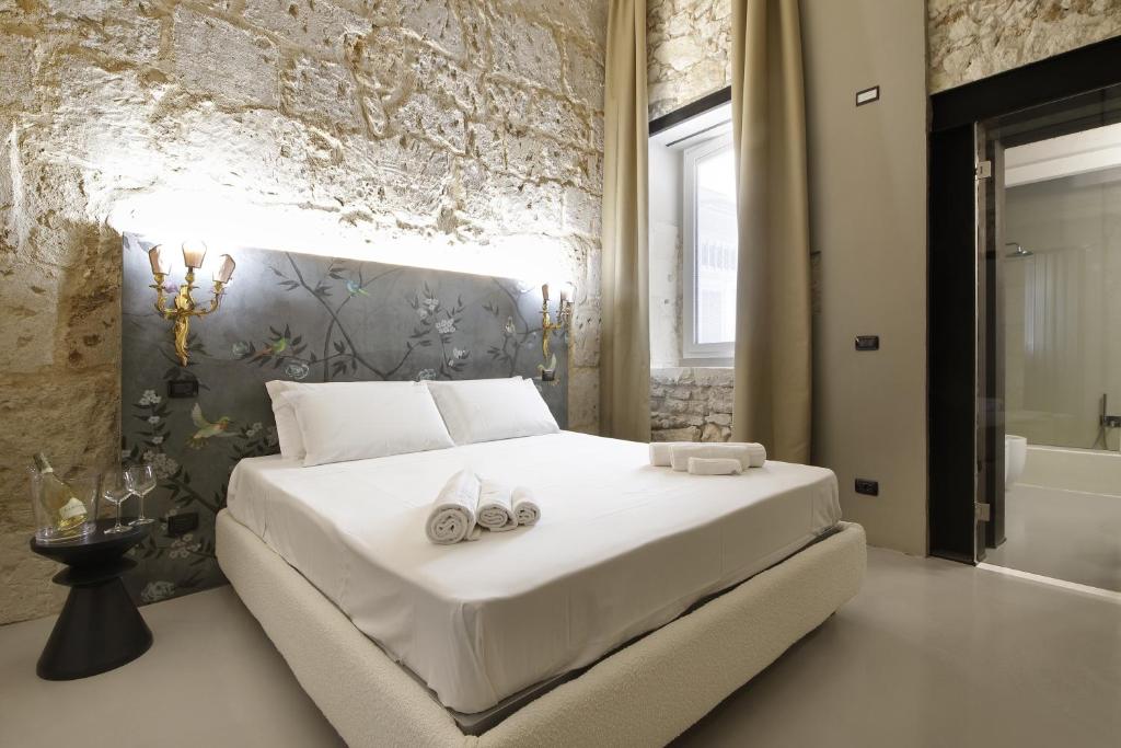 Postel nebo postele na pokoji v ubytování Isonzo Suites Relax