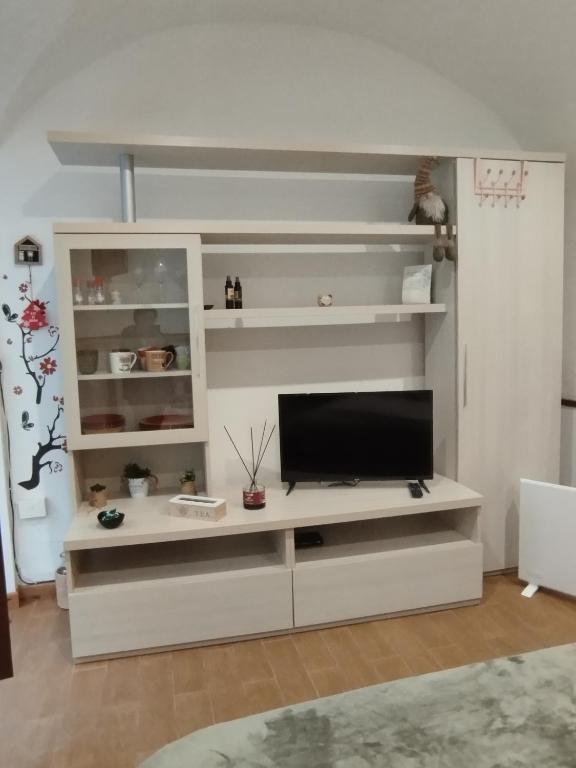 a white entertainment center with a flat screen tv at La casetta di Patry in Tarquinia