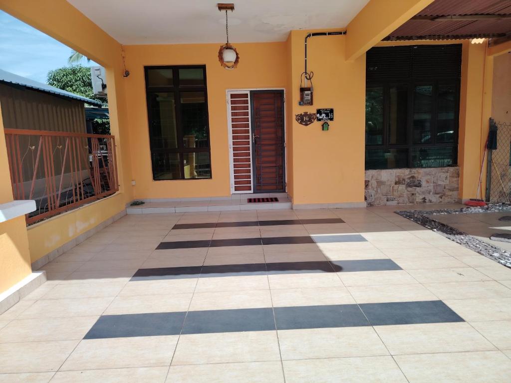 a front porch of a house with a tiled floor at Afwan homestay klebang melaka in Melaka
