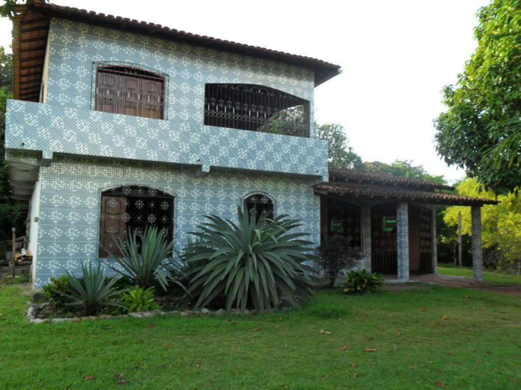 a blue and white house with plants in the yard at Welcome to the Amazon in Ananindeua