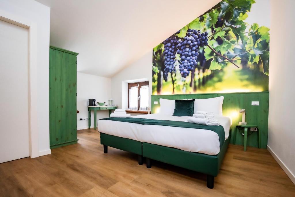 a bedroom with a bed with a painting on the wall at Locanda Il Cavallino in Valeggio sul Mincio