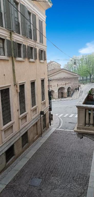 an empty street next to a building on a street at ST. JAMES HOME CITTÀ ALTA in Bergamo