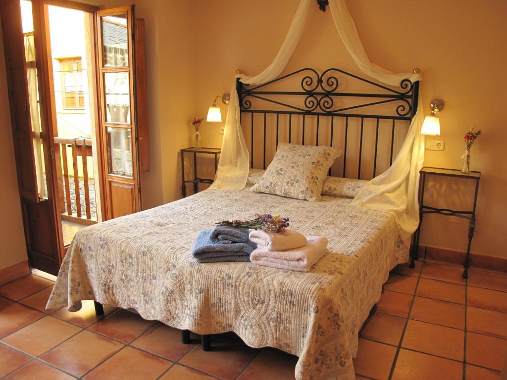 a bedroom with a bed with towels on it at Casa Rural La Torre De Babel in Molinaseca