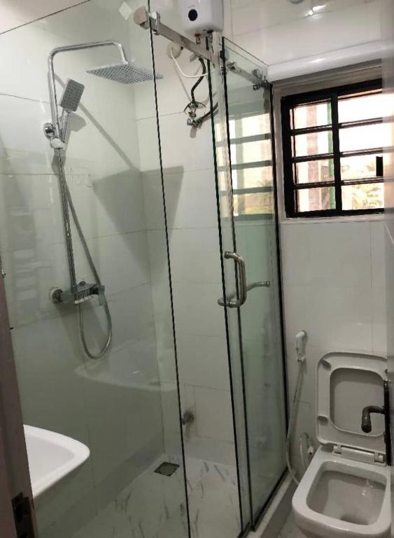 a bathroom with a shower and a toilet at Udokanson Hotel And Suites in Agbor