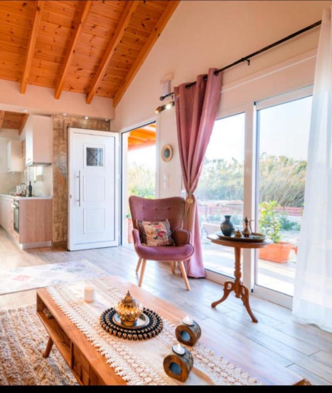 a living room with a couch and a table at Blue Waves House 2 in Soroni