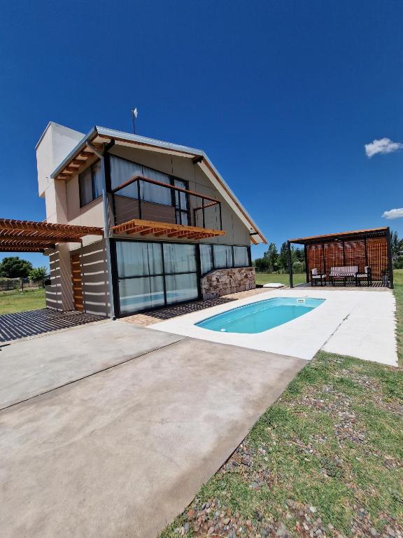 a house with a swimming pool in front of it at Villa Bella vista 2024 in San Rafael