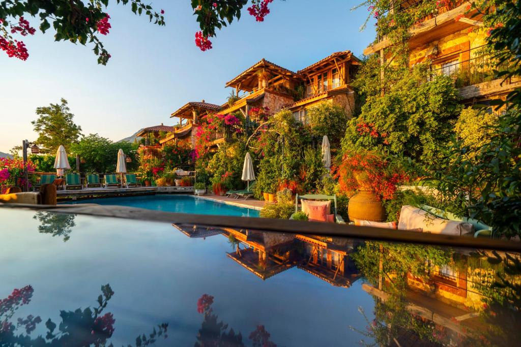 a swimming pool in front of a building at Fidanka Hotel in Kalkan