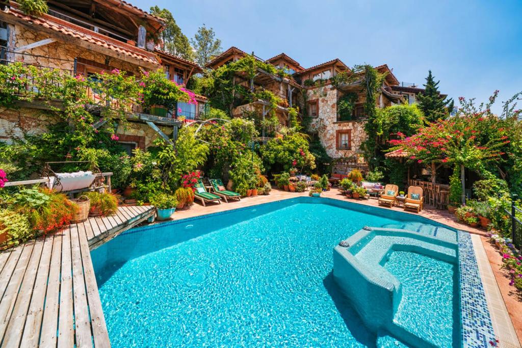 a swimming pool in the yard of a house at Fidanka Hotel in Kalkan