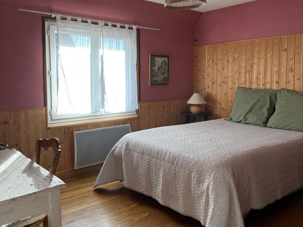 a bedroom with a large bed and a window at Casa Borgognona in Vitteaux