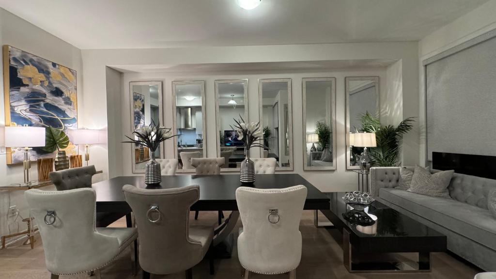 a living room with a dining table and chairs at Ivylea Elegant Luxury Estate Richmond Hill in Richmond Hill