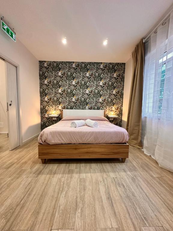 a bedroom with a bed with two lamps on it at La dolce vita Napoli in Naples