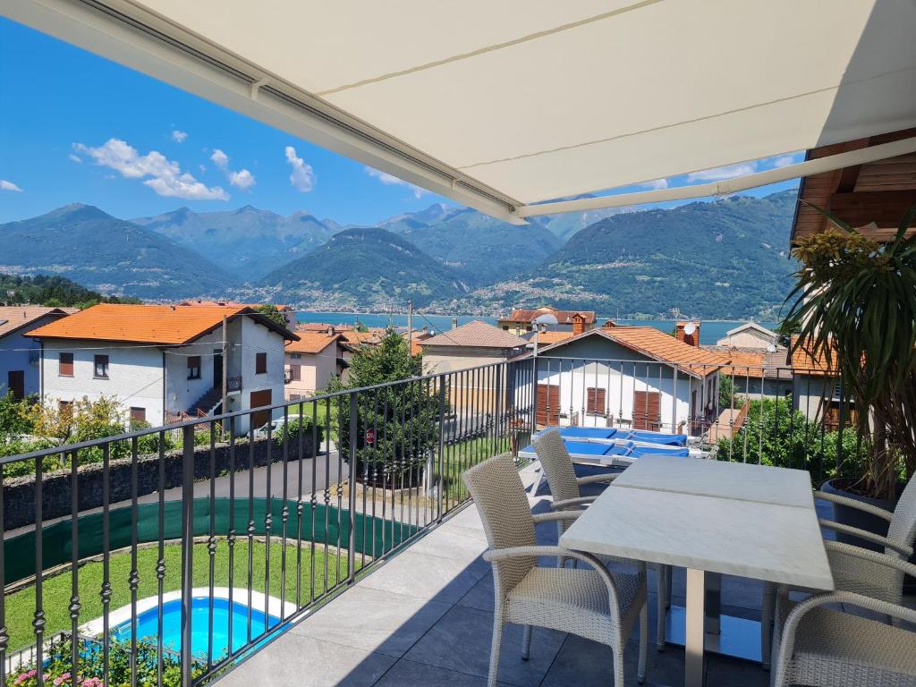 a balcony with a view of a pool and mountains at Riva del Lario Home Colico in Colico