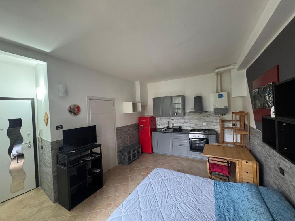a large room with a bed and a kitchen at Appartamento A&S-Centro Argenta in Argenta