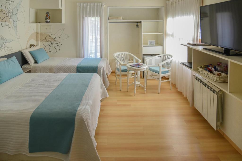 Postel nebo postele na pokoji v ubytování La Morada Petit Hotel