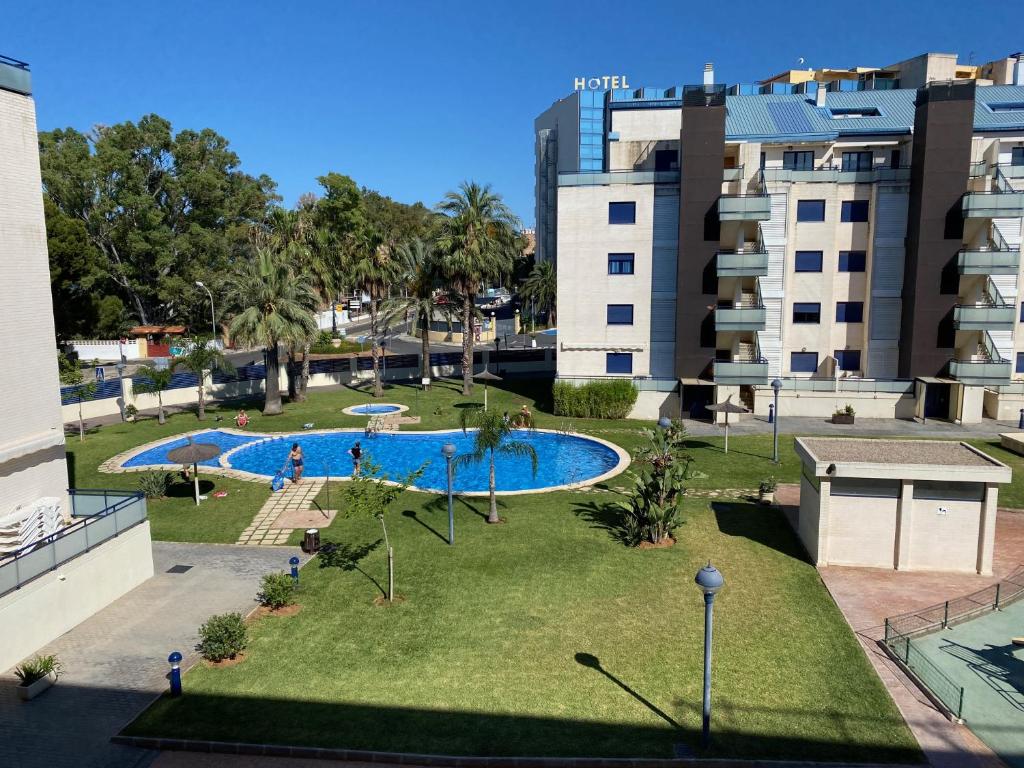 a view of a park with a swimming pool at Apartamento Port Dénia in Denia