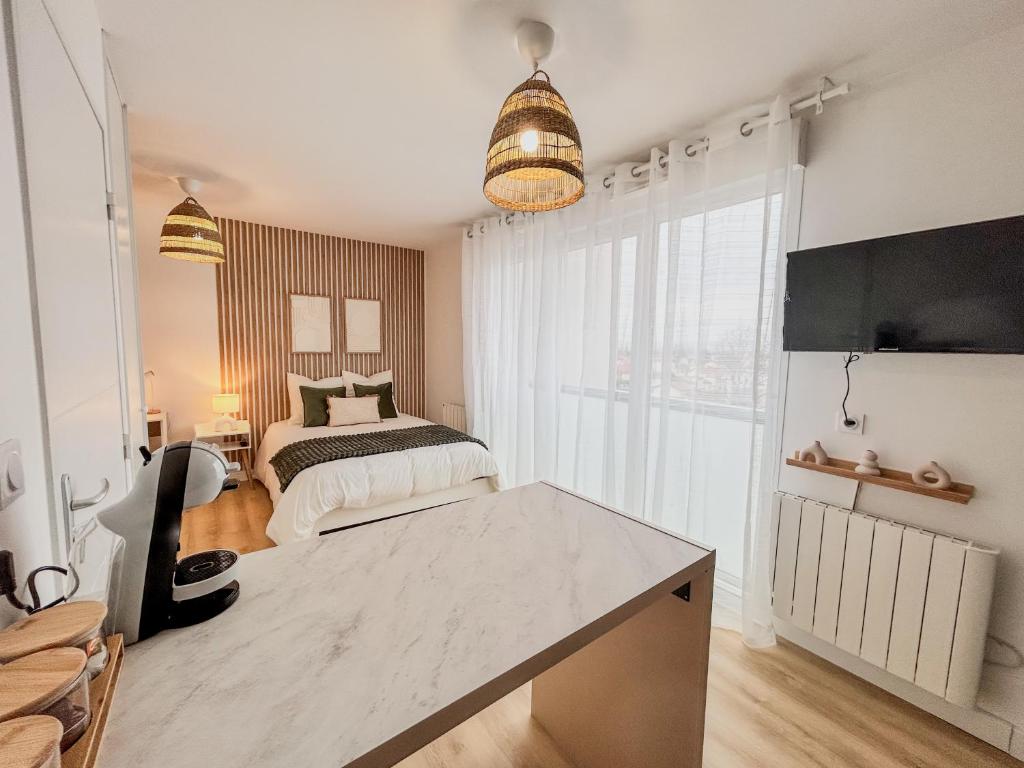 Postel nebo postele na pokoji v ubytování Studio Cosy idéalement situé