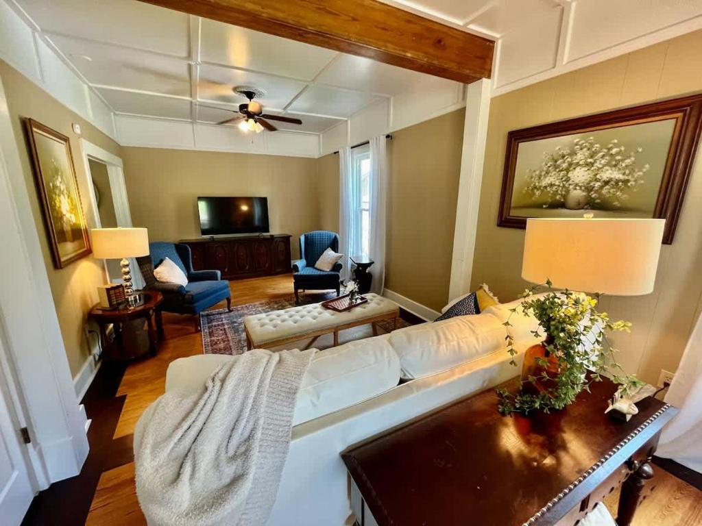 a living room with a white couch and a table at Beit Shalom- House of Peace Family in Siloam Springs