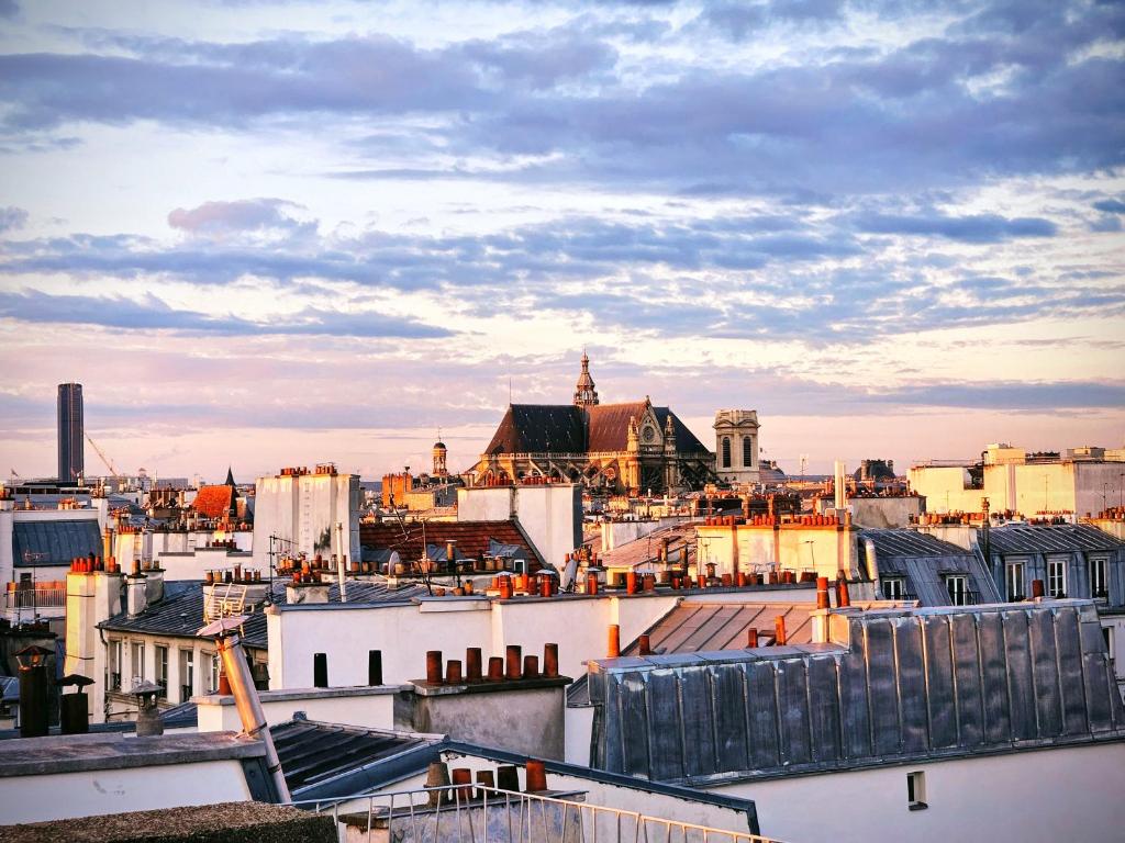 une vue sur les toits d'une ville avec des bâtiments dans l'établissement Studio duplex plein sud refait à neuf - paris 2ème - vue exceptionnelle toits, à Paris