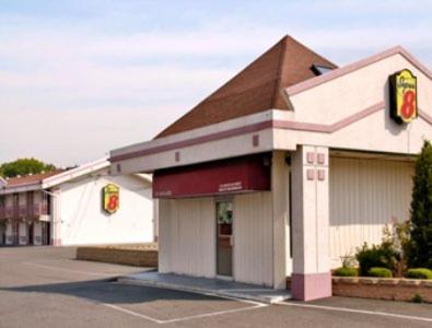 a building with a stop sign in a parking lot at Knights Inn South Hackensasck in South Hackensack