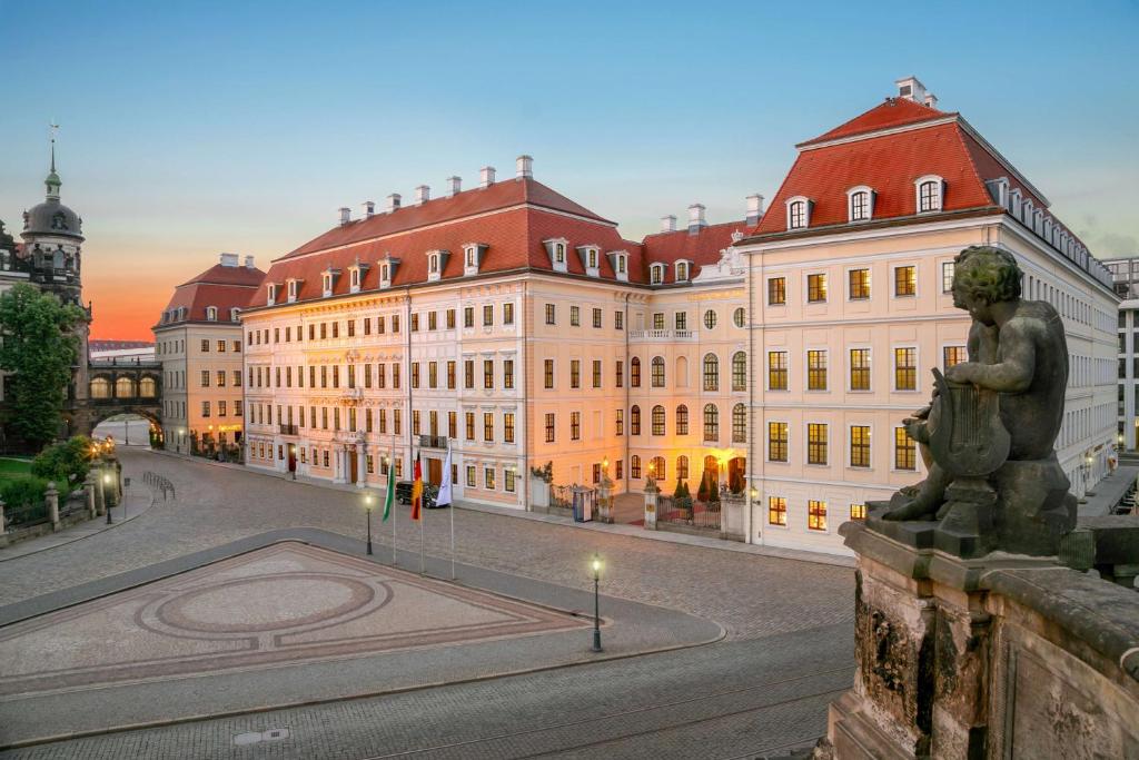 a large building with a statue in front of it at Hotel Taschenbergpalais Kempinski in Dresden