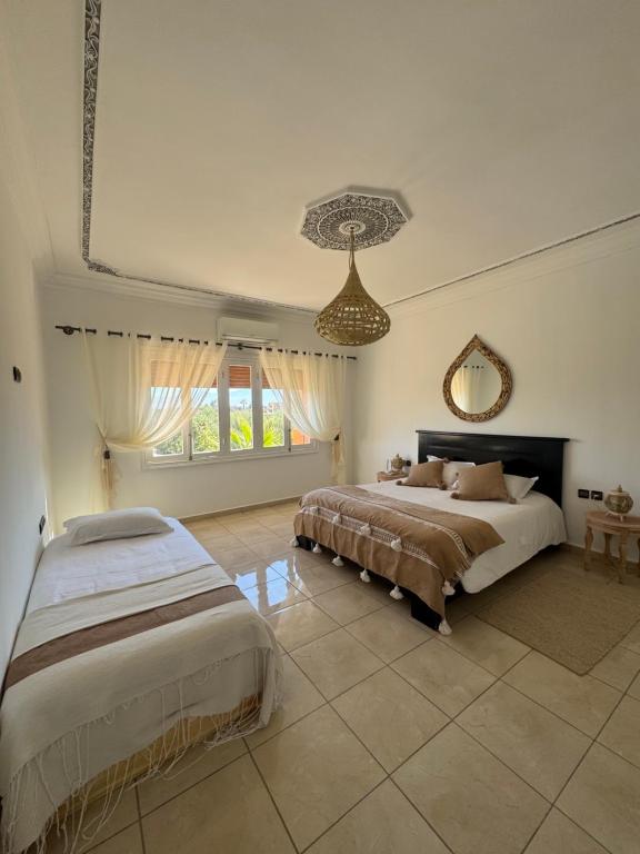 Postel nebo postele na pokoji v ubytování Maison Jannate Louise