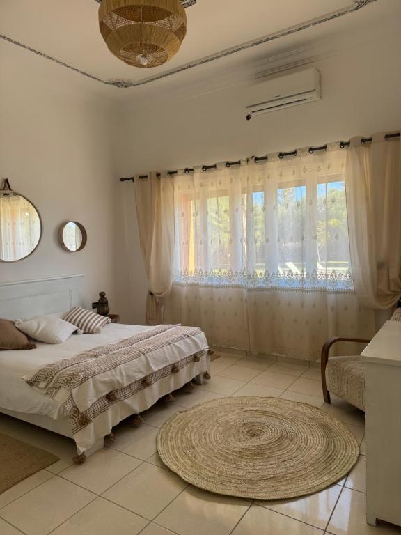 Postel nebo postele na pokoji v ubytování Maison Jannate Louise