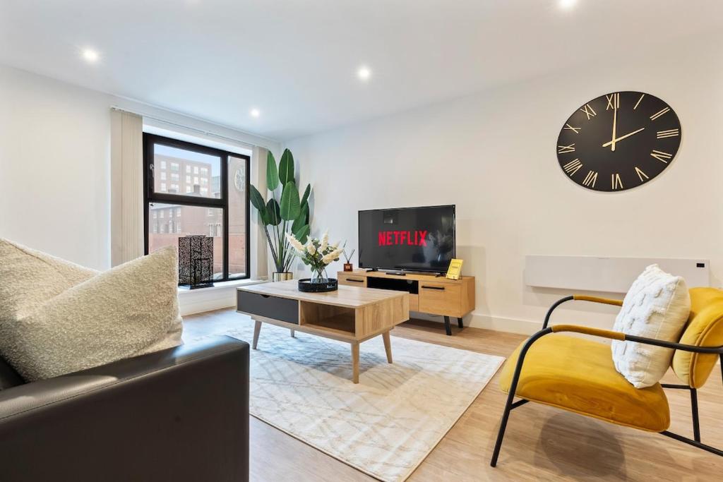 a living room with a clock on the wall at The Grand Central Penthouse - Luxury - Sleeps 4 in Birmingham
