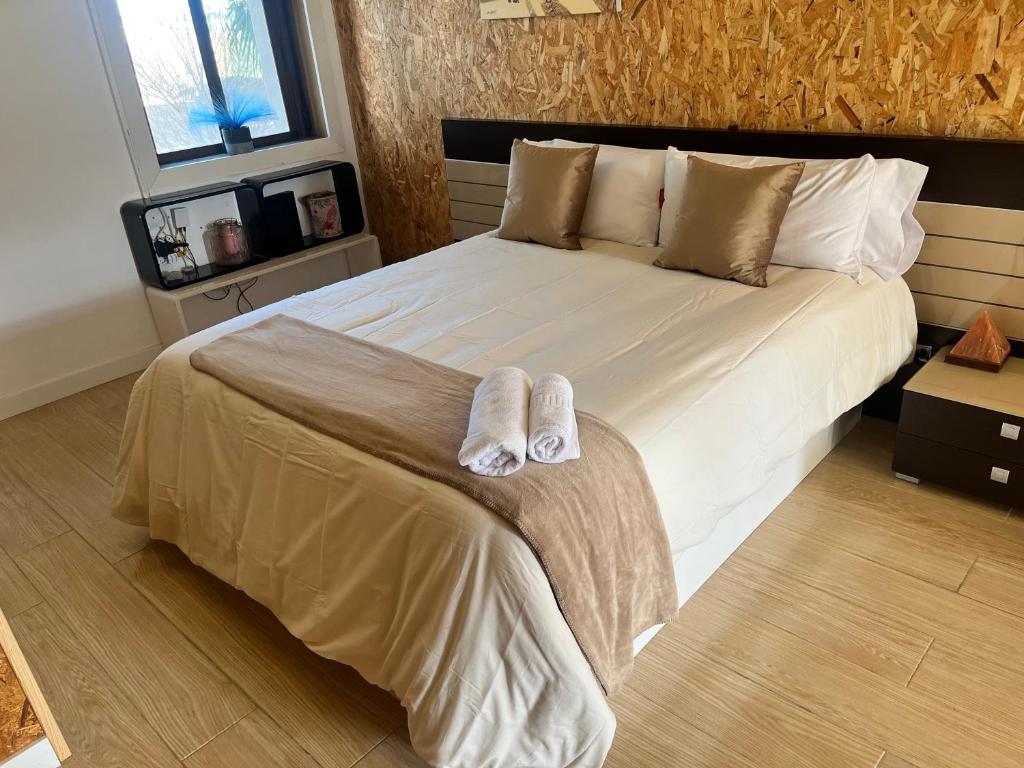a bedroom with a large bed with two towels on it at Exclusivo Loft en Zaragoza-4 in Zaragoza