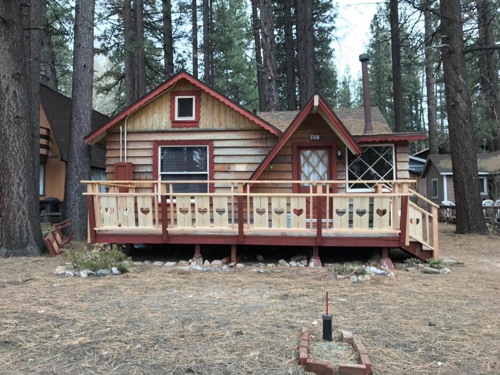 a log cabin with a large deck in the woods at Near the Slopes - Big Bear Mountain getaway in Big Bear Lake