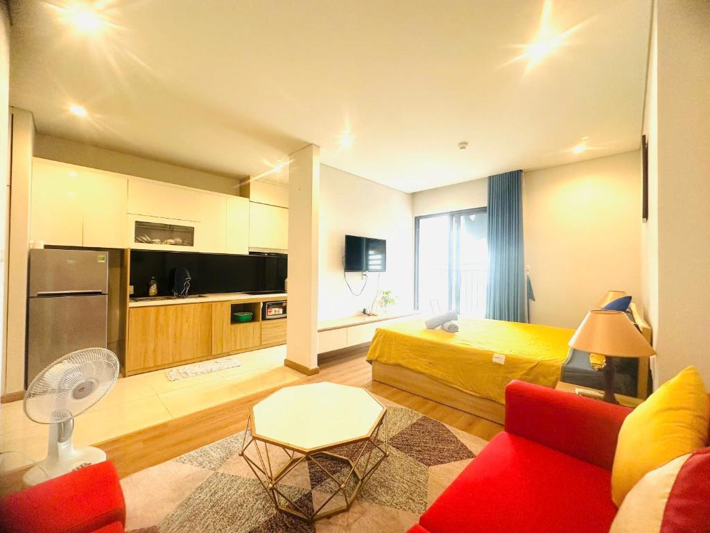 a living room with a bed and a red couch at Golden sunshine studio-Sea view &Nelflix Free in Ha Long