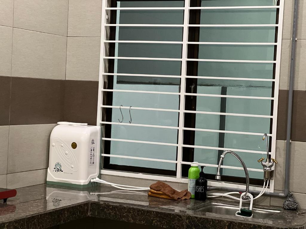a kitchen counter with a sink and a window at Jan2025 New Reno De Blackwood Home in Port Dickson