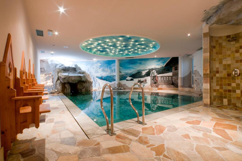 a room with a swimming pool in a house at Hotel Gianna in Madonna di Campiglio