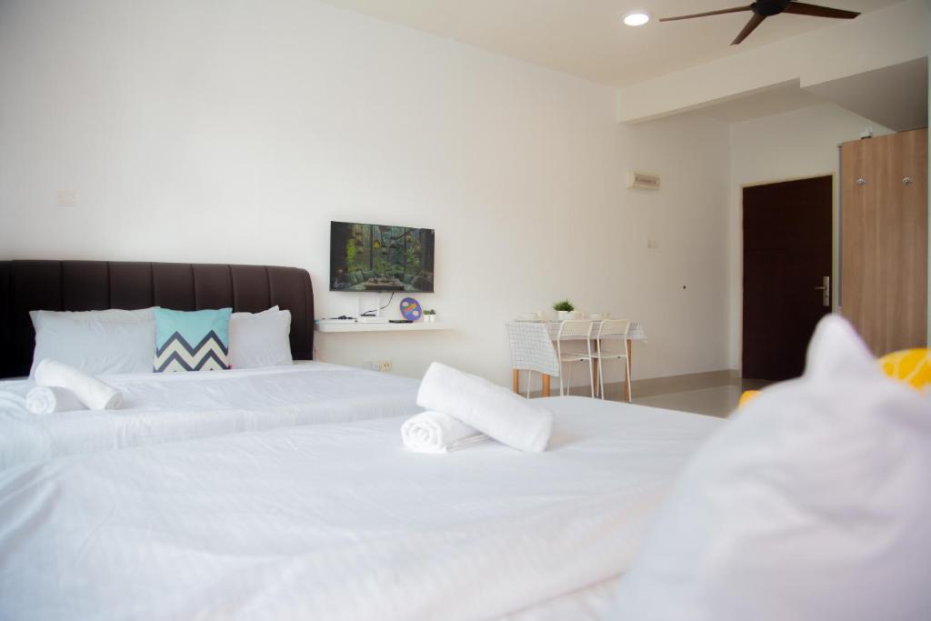 a bedroom with two beds with white sheets at -Mount Austin IKEA, AEON 10mins -Pool View- B215 in Johor Bahru