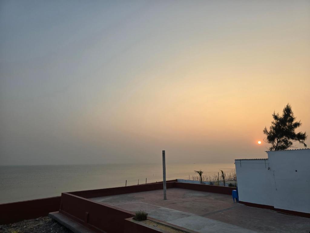 a view of the ocean at sunset at Ricardo Beach Resort in Mandarmoni