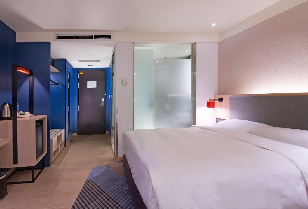Postel nebo postele na pokoji v ubytování Holiday Inn Express Taipei Train Station by IHG