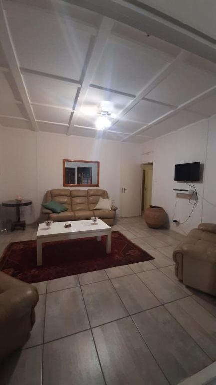 a living room with a couch and a coffee table at Alhoa 1 in Gariep Dam