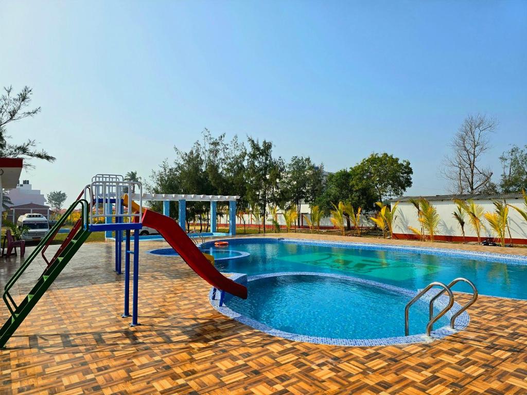 a swimming pool with a slide and a playground at Ricardo Beach Resort in Mandarmoni