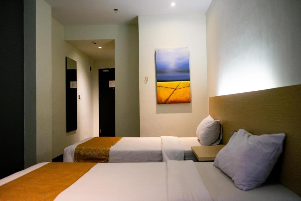 Postel nebo postele na pokoji v ubytování Yunna Hotel Lampung