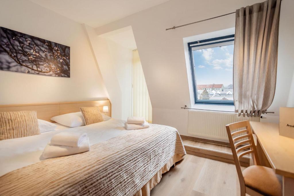 Postel nebo postele na pokoji v ubytování Wine Wellness Hotel Amande Hustopeče